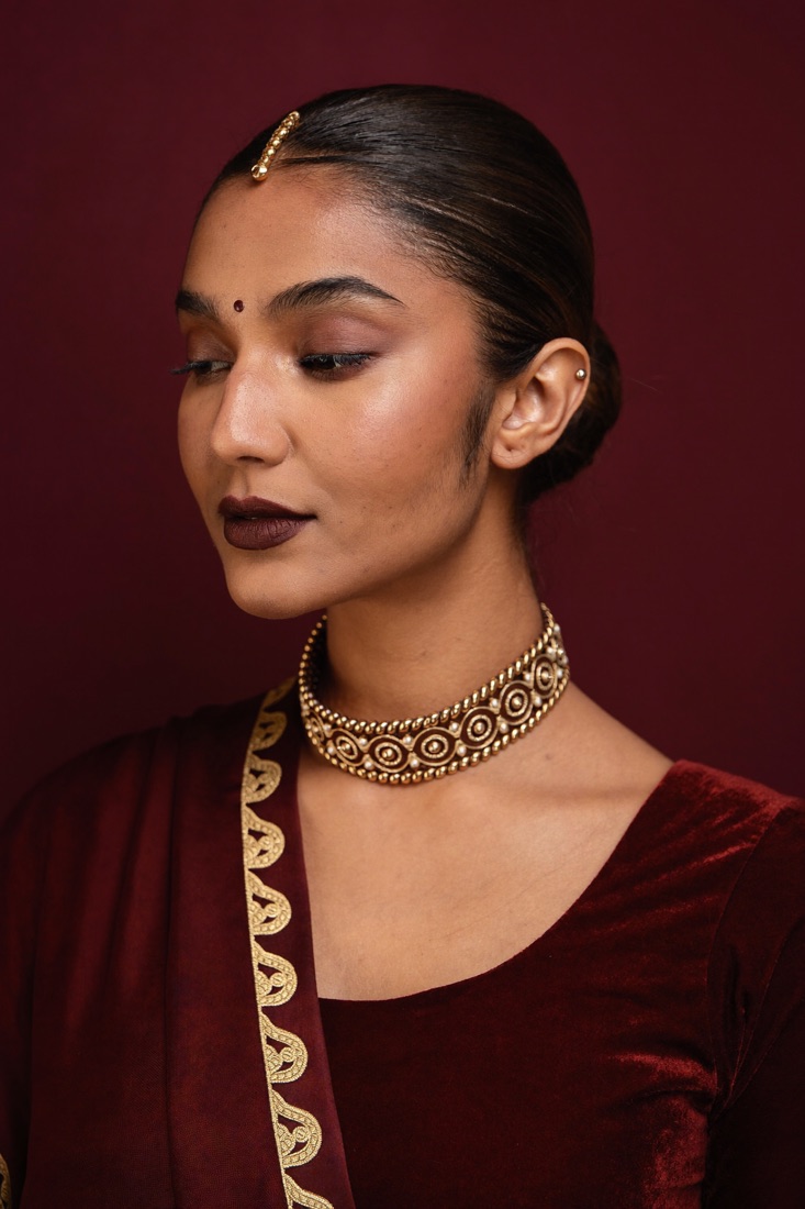 Bride with a matte maroon lip and velvet-finish skin