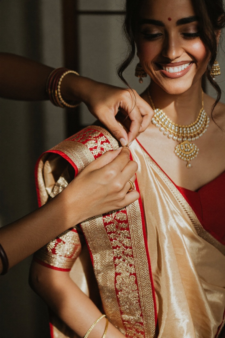 A gold saree draped and pinned
